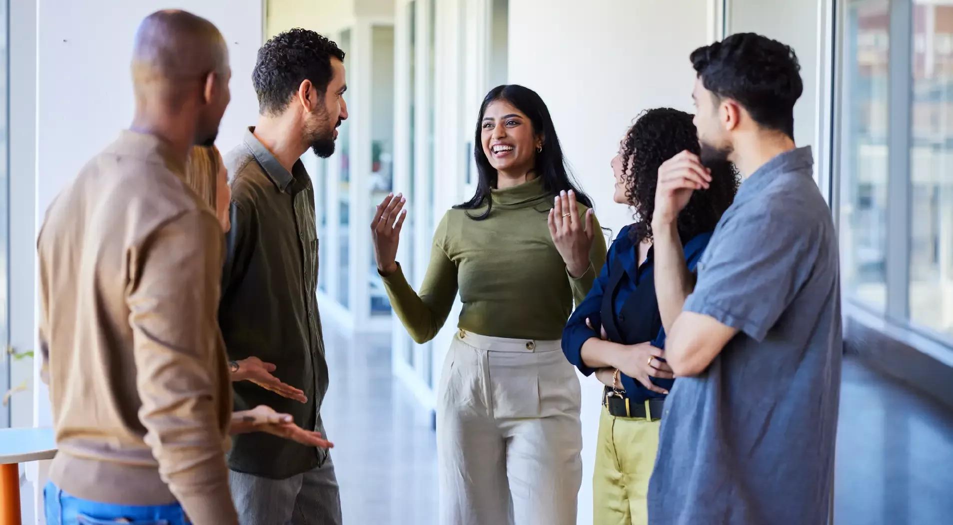 A team of professionals working collaboratively in an office setting, sharing ideas and contributing to a project.
