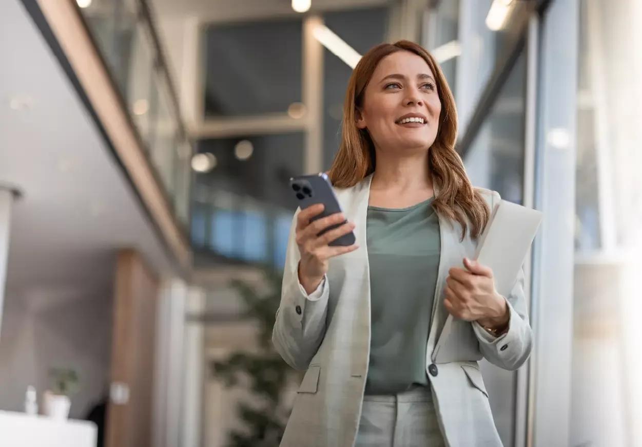 Woman looking out window smiling about syncing FP&A with liquidity planning for true cash forecasting